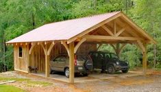 two cars are parked under a wooden carport