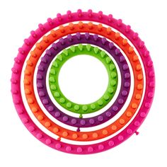 four different colored legos arranged in a circle on top of each other with holes