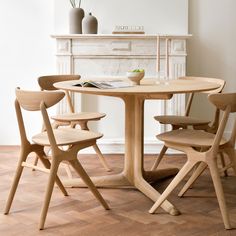 a wooden table with four chairs around it