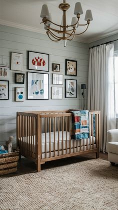 a baby's room with pictures on the wall and a crib in it