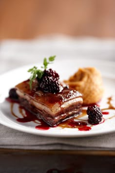 a white plate topped with dessert on top of a table