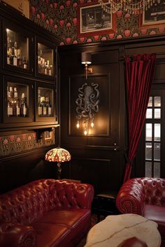 a living room filled with red leather furniture