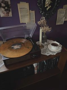 a record player sitting on top of a wooden table