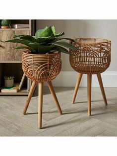 two planters sitting on top of wooden legs