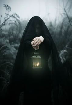 a person with a lantern in their hand