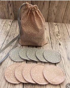 six polka dot coasters and a bag on a wooden table with a drawsack