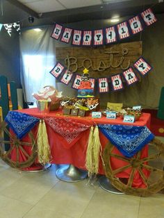 a red table topped with a wagon filled with food