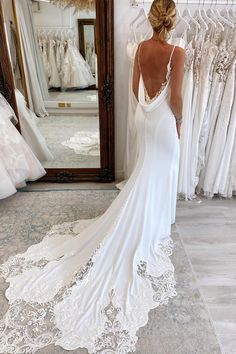 a woman is looking at her wedding dress