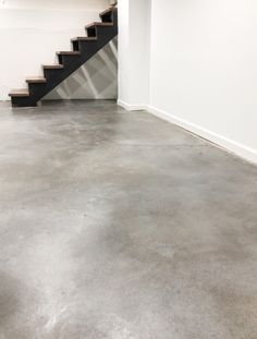 an empty room with stairs leading up to the second floor and a fire hydrant