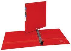 a red binder is open on top of two folders, one with a clip and the other without