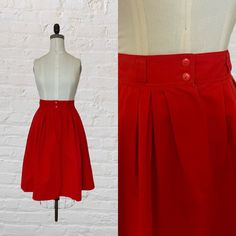 "vintage red high waist full skirt. fitted waist. full silhouette. two button closure & zip fly closure. please waist. hidden hip pockets. falls to above knee length. ○ Circa: 1980s ○ Label: Lord & Taylor ○ Fabric: Cotton ○ Color: Red ○ Condition: Excellent. No notable flaws. Modern Size Estimate: Small ⦿ Tag reads size 10 ⦿ Waist: 26/27\" ⦿ Hips: free ⦿ Length: 25.5\" All measurements are taken flat. ❉ this is a vintage item and there is ONLY one! Item no. LT1805 This garment has been dry clean Red Retro Pleated Skirt, Vintage Red Skirt For Workwear, Vintage Red Skirt For Work, Retro Red Pleated Bottoms, Retro Red Pleated Skirt, Fitted Red Skirt With Button Closure, Vintage Red Full Skirt Bottoms, Red Vintage Flared Skirt, Vintage Red Knee-length Skirt