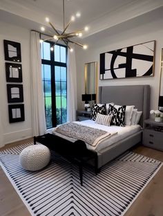 a large bed sitting in a bedroom on top of a white and black carpeted floor