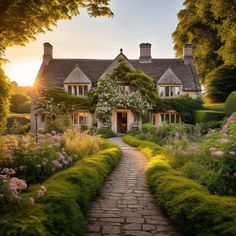 a house that is surrounded by bushes and flowers