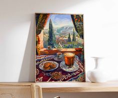 a painting hanging on the wall above a table with plates and cups in front of it