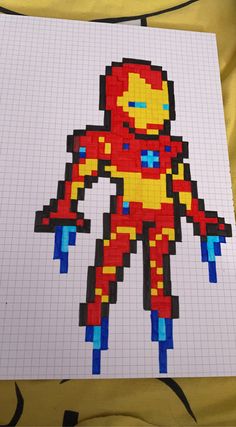 a drawing made out of legos on top of a sheet of paper with an image of iron man