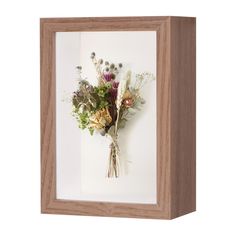 a wooden frame with flowers in it on a white background and an empty box underneath