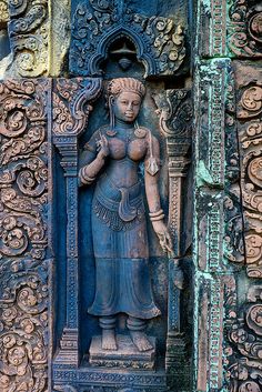 an intricately carved statue on the side of a building