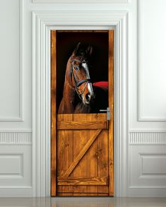 a horse sticking its head out of a barn door