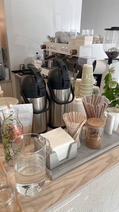 there are many different items on the counter in this room, including cups and saucers