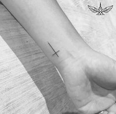 a woman's foot with a cross tattoo on it