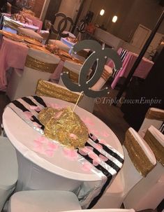 the table is decorated with pink, gold and black decorations for a 30th birthday party