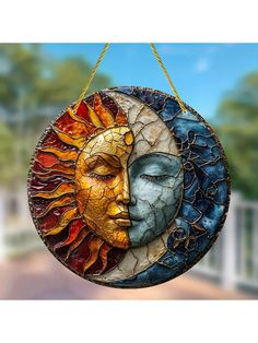 a sun and moon decoration hanging from a string