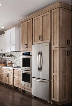 a kitchen with wooden cabinets and stainless steel appliances