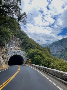 a road going into a tunnel in the mountains