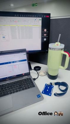 an open laptop computer sitting on top of a desk next to a cup and mouse