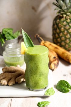 a green smoothie with a pineapple on the side