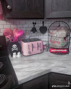 a pink toaster sitting on top of a kitchen counter next to a microwave oven