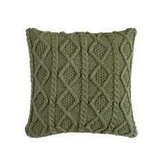 a green knitted pillow on a white background