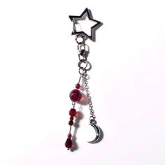 a red beaded necklace with a star hanging from it's side and a crescent