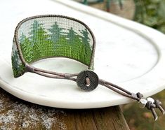 a white surfboard with a green beaded bracelet on it