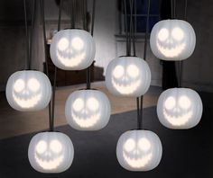 a bunch of lights that are hanging up in the air with a skull face on them