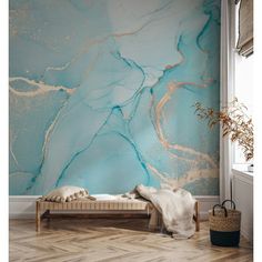 a blue and gold marble wall mural in a room with wooden flooring, white walls and