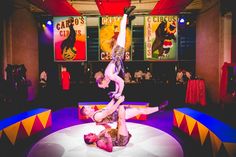 two circus acrobats doing tricks on the floor