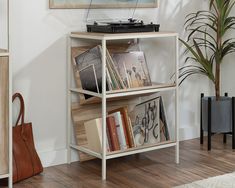 a record player is sitting on top of a book shelf