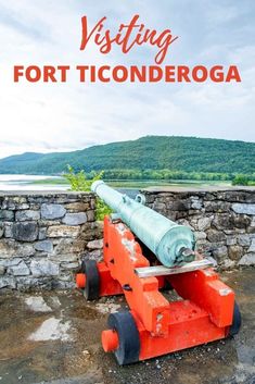 an orange cannon with the words visiting fort ticonderoga on it's side