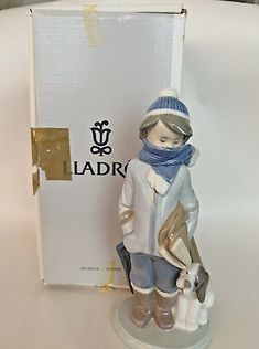 a porcelain figurine is shown in front of a box