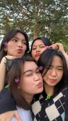 four young women are posing for the camera