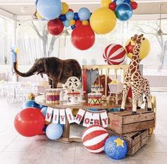 an animal themed birthday party with balloons and decorations