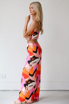 A bold summer look like the Outstanding Cutie Orange Jumpsuit was made for warm sunny days! This eye-catching piece features a stunning array of vibrant colors and dynamic patterns, creating a unique and artistic look that stands out from the crowd. The cinched waist accentuates your silhouette, while the wide-leg pants provide a flowing, elegant drape that adds a touch of sophistication to your ensemble. Crafted from a lightweight, breathable fabric, this jumpsuit is ideal for warm-weather occa Orange Tropical Print Swimwear For Spring, Multicolor Bold Print Swimwear For Summer, Patterned Sleeveless Spring Swimwear, Multicolor Printed Swimwear For Summer Parties, Vibrant Summer Swimwear, Bold Multicolor Swimwear For Vacation, Vibrant Multicolor Print Swimwear For Summer, Colorful Vibrant Print Swimwear For Summer, Multicolor Swimwear For Day Out