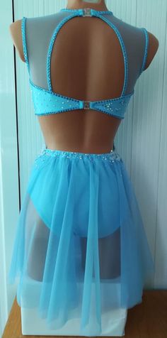 the back of a woman's dress with blue tulle