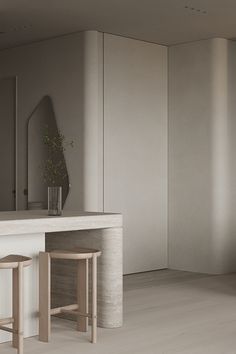 two stools sit in front of a counter with a mirror and vase on it