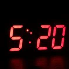 a red digital clock displaying the time on a black background