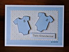 a card with two baby ones on it and the words twin grandson written in white