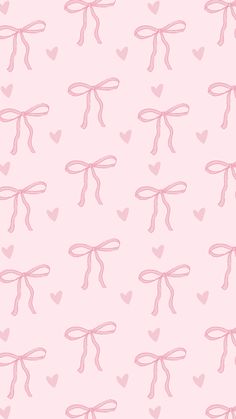 pink bows and hearts on a light pink background seamless wallpaper with heart shapes