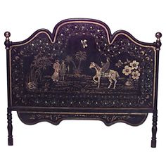 an ornately decorated bed frame with horses and flowers