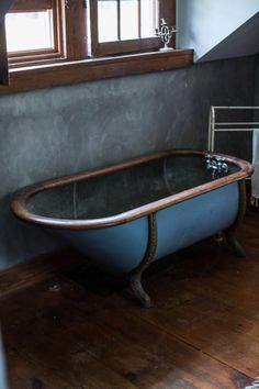 an old fashioned bath tub in a bathroom